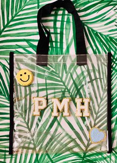 a plastic bag with the word pmh on it and a smiley face embellishment