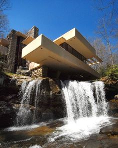 a waterfall in front of a modern house