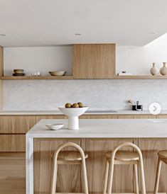 two stools are in front of the kitchen counter