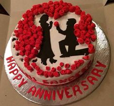 a red and white cake with the words happy anniversary on it