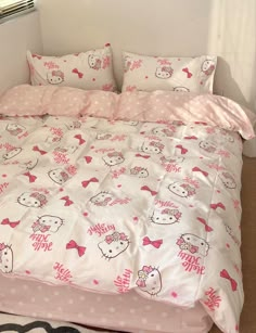 a bed with hello kitty sheets and pillows