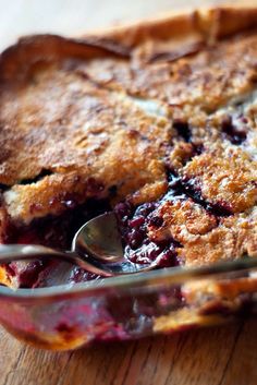 a close up of a pie on a table with a spoon in the foreground