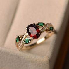 This ring features a 6*8mm oval cut natural garnet and marquise cut lab emerald. Customization is available. It is made by hand, and it will take about 7 days to finish the ring after your payment is completed. Main stone: Natural garnet Main stone weight: Approx 1.73 ct Metal type: 14k yellow gold Accent stone: lab emerald and cz Customization is available, I also can make it with 14k solid gold (white or yellow or rose) and diamond accent stone, just feel free to contact me. Any question, just Luxury Ruby Ring With Gemstone Accents For Promise, Luxury Ruby Ring With Gemstone Accents For Wedding, Luxury Emerald Cut Ruby Birthstone Ring, Luxury Ruby Birthstone Ring With Gemstone Accents, Luxury Ruby Gemstone Ring As Gift, Luxury Silver Ruby Ring Stackable, Luxury Ruby Gemstone Ring Gift, Luxury Silver Ruby Ring, Elegant Style, Luxury Ruby Birthstone Ring For Engagement