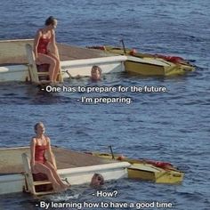 two women in red swimsuits sitting on the edge of a dock