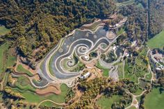 an aerial view of a track in the middle of a wooded area with lots of trees