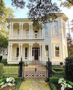 a large white house with black iron gates