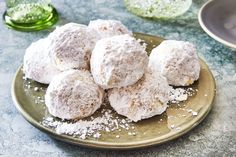 powdered sugar covered donuts on a gold plate