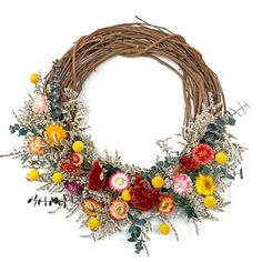 a wreath with flowers and leaves on it