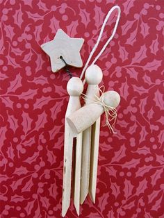 an ornament made out of popsicle sticks with a wooden star on top