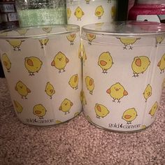 two plastic buckets with yellow chicks on them