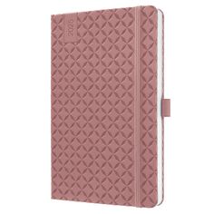 a pink notebook with an intricate pattern on the cover