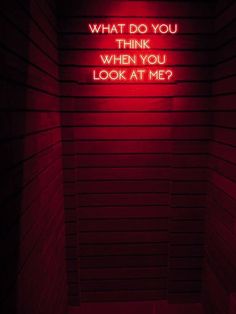 a red neon sign that says what do you think when you look at me?