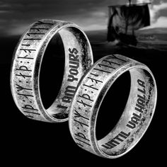 two rings with words on them sitting next to each other in front of a boat