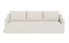 a white couch with four pillows on it