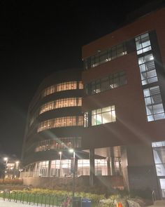 an office building lit up at night time