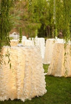 the tables are covered with white ruffled cloths