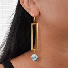 Catch some beach vibes with our Sandy Beaches Earrings! These blue and gold beauties feature a fun ocean print and a long rectangle charm. Perfect for adding a touch of seaside charm to any outfit. Due to the handmade nature of this product, no two earrings are exactly the same. Product Details 3.5" long x 0.75" wide Gold plated french hooks, nickel free Raw brass charm Gold plated pendant tray Glass cabochon Cotton fabric Care Instructions Keep earrings dry, remove when cleaning or near water. Clean with a soft cloth. Store in a dry, enclosed container. Handmade Fabric Earrings, Two Earrings, Cloth Store, Beach Earrings, Magnetic Earrings, Fabric Earrings, Gold Beauty, Coffee Sleeve, Ocean Print