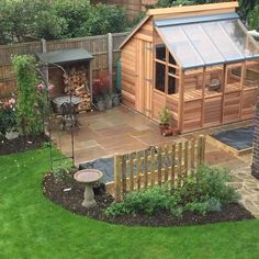 a backyard with a wooden shed and garden furniture