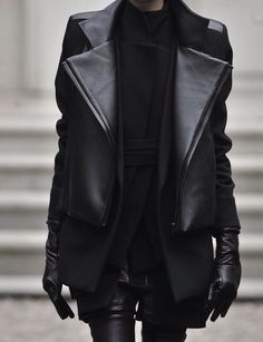 a man in black leather clothes and gloves on the runway at givenchy fashion show