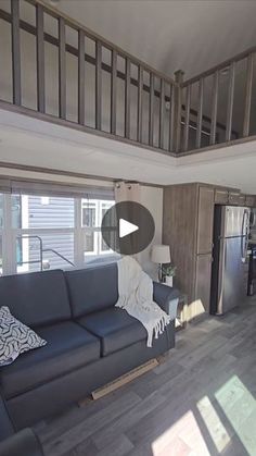 a living room filled with furniture next to a kitchen