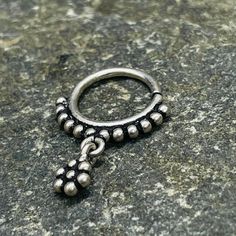 This dazzling silver tribal piece can be worn as a septum, earrings, helix, or tragus . It features a delicate tiny flower hanging in the middle, adding a touch of elegance to any look. 1mm wire - 18 Gauge  Please know your size piercing before making a purchase. All piercings are not returnable due to hygiene and for your safety. Elegant Silver Hypoallergenic Septum Ring, Silver Nickel-free Nose Rings, Silver Pierced Metal Nose Rings, Nickel Free Silver Metal Nose Rings, Elegant Internally Threaded Silver Septum Ring, Nickel-free Silver Metal Nose Ring, Elegant Adjustable Silver Nose Rings, Internally Threaded Dangle Piercings In Sterling Silver, Silver Internally Threaded Teardrop Piercings