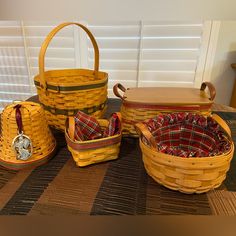 four woven baskets with plaid linings on the floor