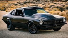 an old muscle car is parked in the desert