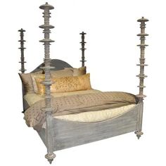 a bed with four posts and pillows on it