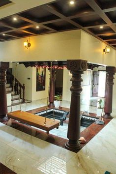 a living room filled with furniture and lots of wood posts on the ceiling, along with marble flooring