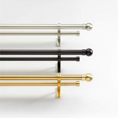 four different types of curtain rods on a white background with gold, black and silver handles