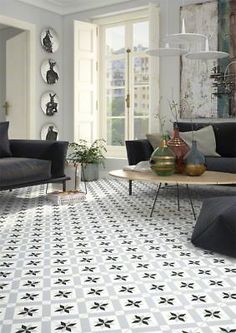 a living room with black and white tiles on the floor