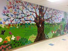 a colorful mural on the side of a building with trees and flowers painted on it