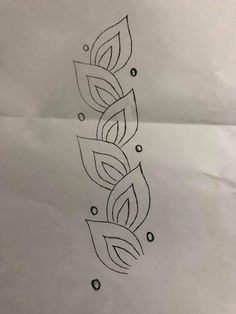 a tattoo design on paper with leaves and dots in the middle, as well as water droplets