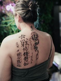 a woman with chinese writing on her back