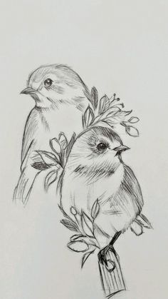 two birds sitting on top of a branch with leaves and flowers in their beaks