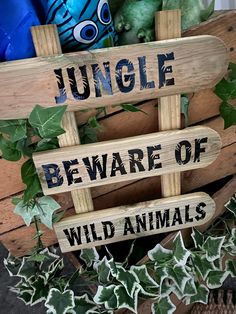 a wooden sign that says jungle beware of wild animals