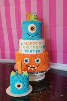 a three tiered birthday cake with monsters on it