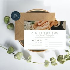 a gift for you is displayed on top of a plate with greenery around it