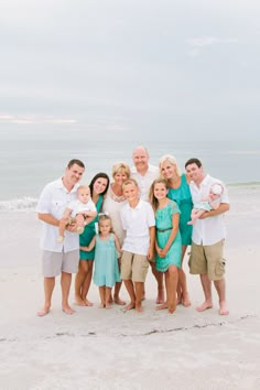 a family poses for a photo on the beach