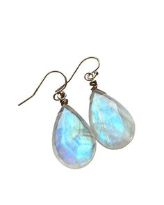 THESE rainbow moonstone EARRINGS ARE NOT BLUE- they are white the colors are seen when viewed in bright direct sunlight. Paired perfectly lightweight on comfortable fishhooks. These Handcrafted faceted rainbow moonstone earrings will make the perfect gift for women, available in 14kt gold fill or sterling silver. The earrings are made to order and will be just as beautiful as the pair pictured! Handcrafted Moonstone Earrings *Perfect gift for her *High quality stones offer stunning unique charac Moonstone Drop Earrings For Gift, Hypoallergenic Moonstone Dangle Earrings, Hypoallergenic Moonstone Drop Earrings, Moonstone Teardrop Earrings With Natural Stones, Moonstone Teardrop Gemstone Earrings, Drop Moonstone Earrings With Natural Stones, Teardrop Moonstone Gemstone Earrings, Moonstone Briolette Jewelry With Ear Wire, Drop Earrings Gold