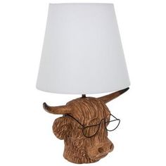 a wooden bull head lamp with a white shade on it's face and eye glasses