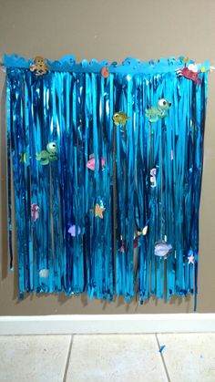 an ocean scene made out of blue streamers and plastic straws with fish on them