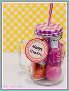 a jar filled with pink and purple items on top of a white tablecloth next to a yellow polka dot wall