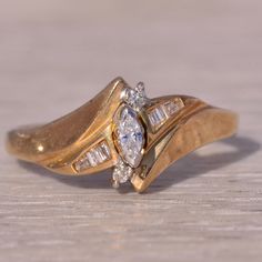 a gold ring with two diamonds on it