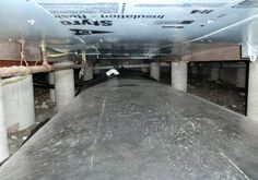 the inside of an underground parking garage with pipes