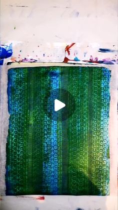 an abstract painting with blue, green and white stripes on it's edges is featured in the video