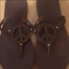 American Eagle Peace Sign Sandals Casual Brown Flat Sandals, Brown Casual Slip-on Flip Flops, Comfortable Brown Round Toe Flip Flops, Comfortable Brown Slip-on Flip Flops, Comfortable Brown Closed Toe Flip Flops, Comfortable Brown Flip Flops, Casual Brown Flip Flops For Vacation, Casual Brown Open Toe Flip Flops, Brown Flat Flip Flops