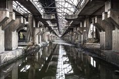 an abandoned building with water running under it