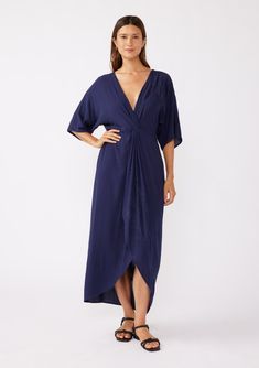 [Color: Navy/Navy] A brunette model wearing a blue front knot maxi dress with a tonal embroidery. Featuring a deep v neckline Beach Maxi Dress With Knotted Straps And V-neck, Beach V-neck Maxi Dress With Knotted Straps, Relaxed Fit V-neck Maxi Dress For Beachwear, Relaxed Fit V-neck Beachwear Maxi Dress, Blue V-neck Rayon Maxi Dress, Strappy Flats, Maxi Dresses Fall, Bohemian Maxi Dress, Maxi Dress Navy