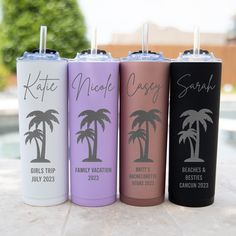 four personalized tumblers with palm trees and names on them sitting next to a pool